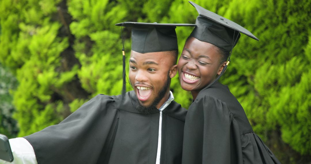 Joyful Graduates Celebrating With Selfie in Park