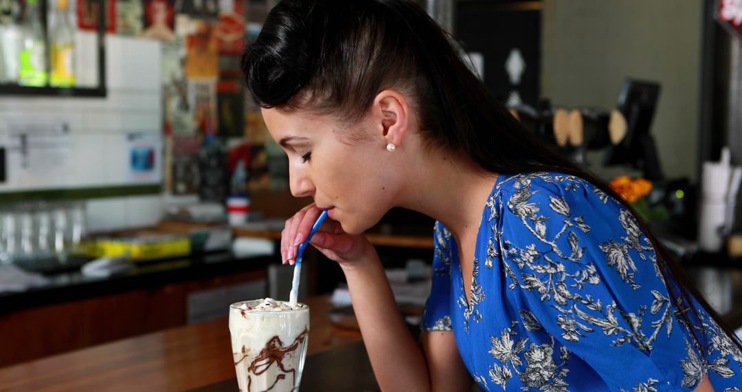 Woman Enjoying Milkshake at Café - Free Images, Stock Photos and Pictures on Pikwizard.com