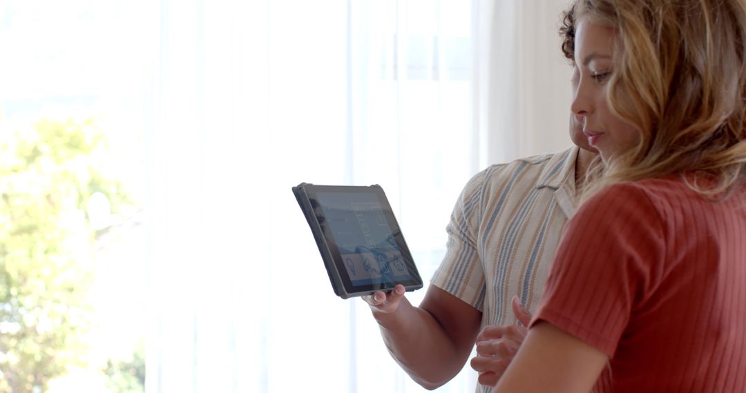 Couple Relaxing at Home with Tablet Proximity Modern Home Interior