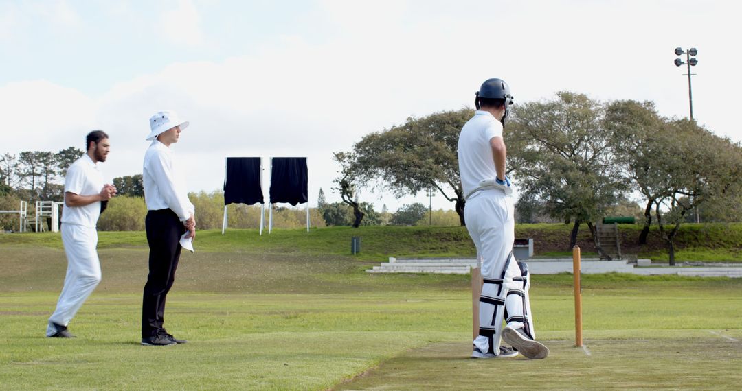 Cricket Match Preparation with Players and Umpire on Field