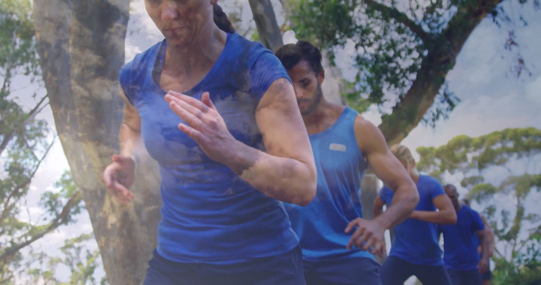 Running Group Training Outdoors on Tree-Lined Trail for Fitness