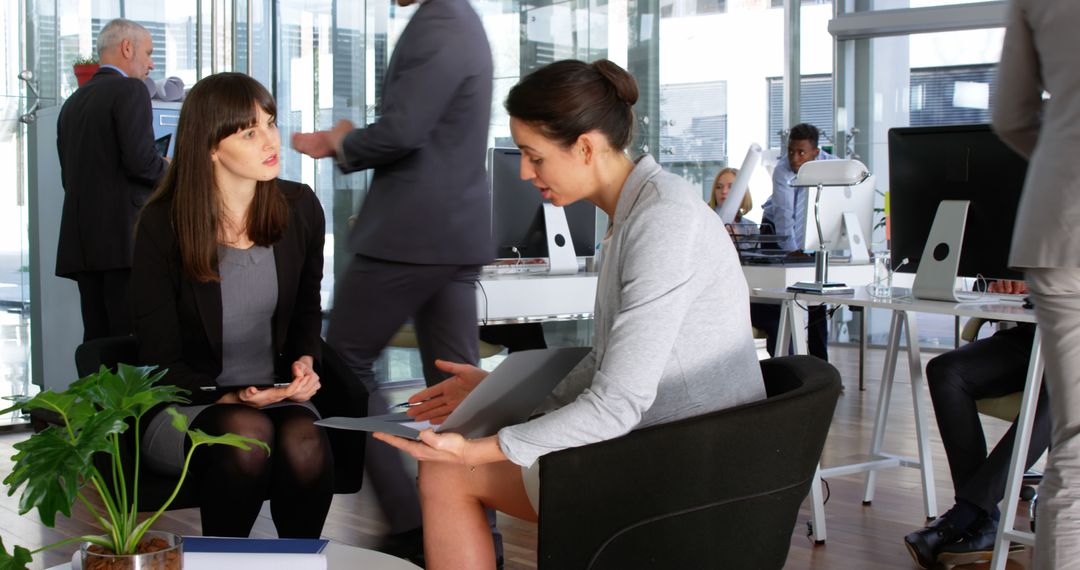 Businesswoman offering advice in busy office - Free Images, Stock Photos and Pictures on Pikwizard.com