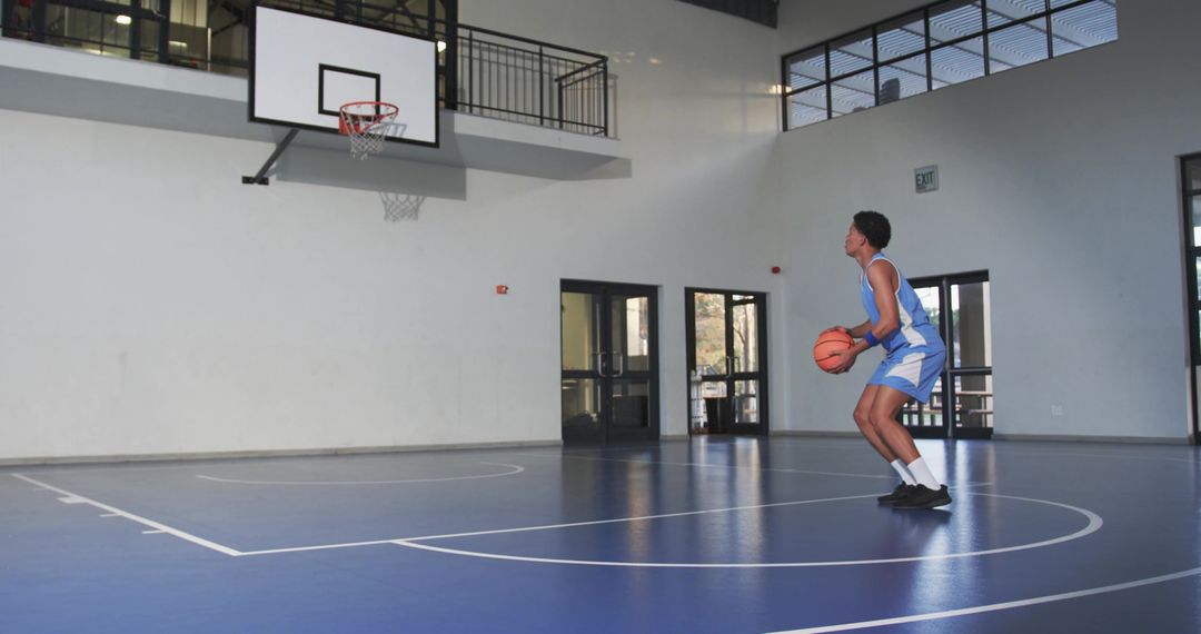Young Basketball Player Focused on Shooting Practice Indoors