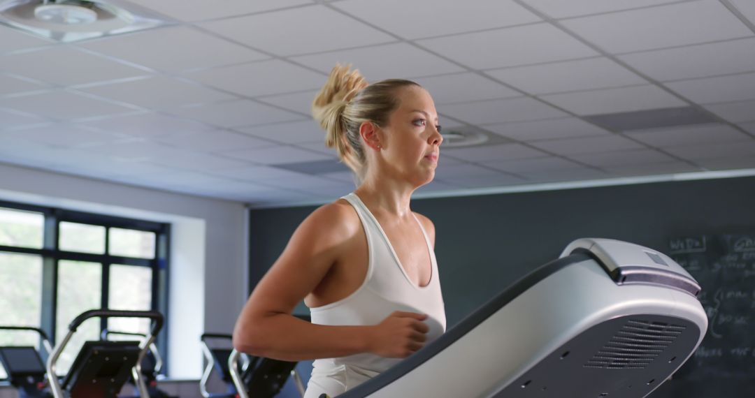 Fitness Woman Running on Treadmill in Modern Gym - Free Images, Stock Photos and Pictures on Pikwizard.com