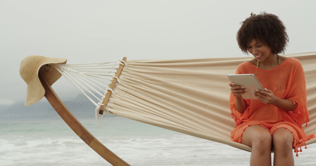 Young Woman Relaxing on Hammock at Beach with Digital Tablet - Free Images, Stock Photos and Pictures on Pikwizard.com