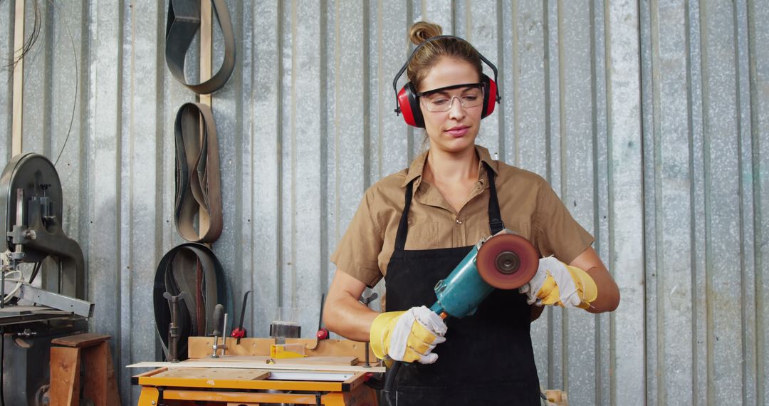 Woman Using Angle Grinder in Metal Workshop - Free Images, Stock Photos and Pictures on Pikwizard.com