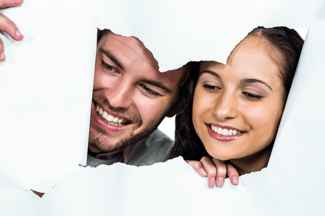 Smiling Couple Peeking Through Torn Paper Opening