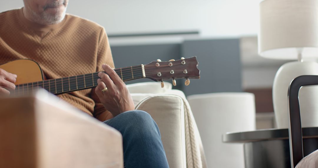 Senior Man Playing Guitar in Relaxing Home Environment - Free Images, Stock Photos and Pictures on Pikwizard.com