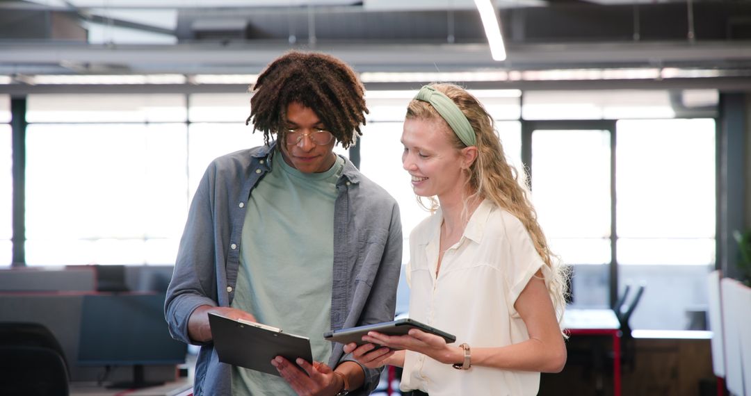 Diverse Office Team Discussing Documents in Modern Workspace