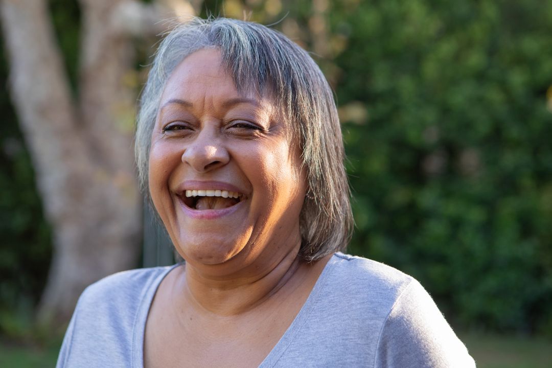 Joyful Senior Woman Smiling in Garden Setting