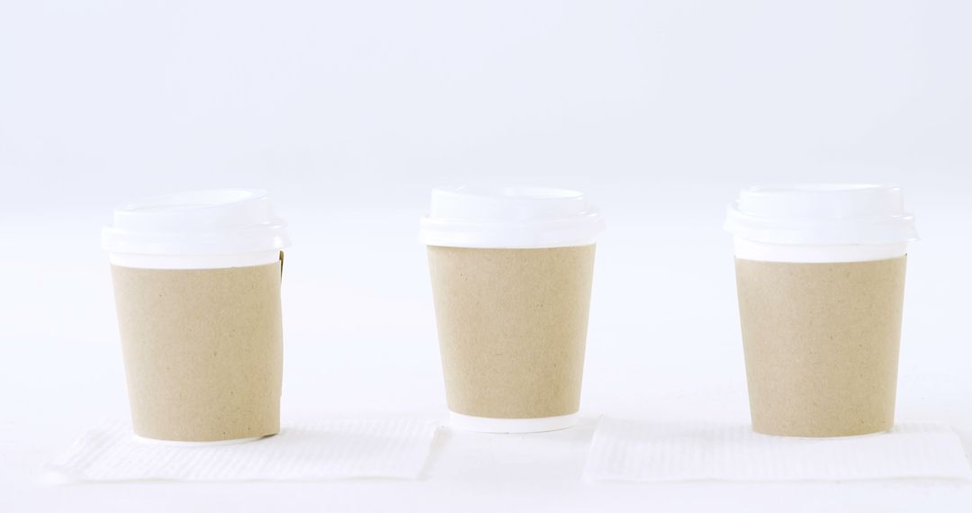 Three Disposable Coffee Cups on White Background - Free Images, Stock Photos and Pictures on Pikwizard.com