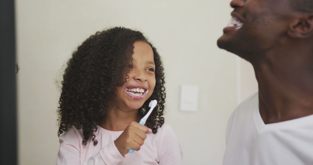 Father and Daughter Brushing Teeth Together, Enjoying Morning Routine - Free Images, Stock Photos and Pictures on Pikwizard.com