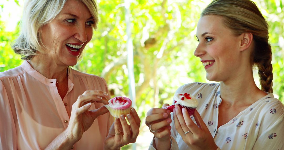 Two Women Enjoying Cupcakes Outdoors - Free Images, Stock Photos and Pictures on Pikwizard.com