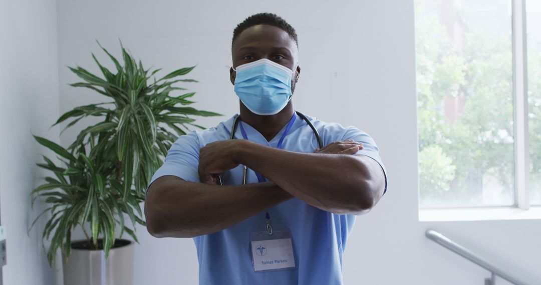 Confident African American Male Nurse with Arms Crossed in Medical Facility - Free Images, Stock Photos and Pictures on Pikwizard.com