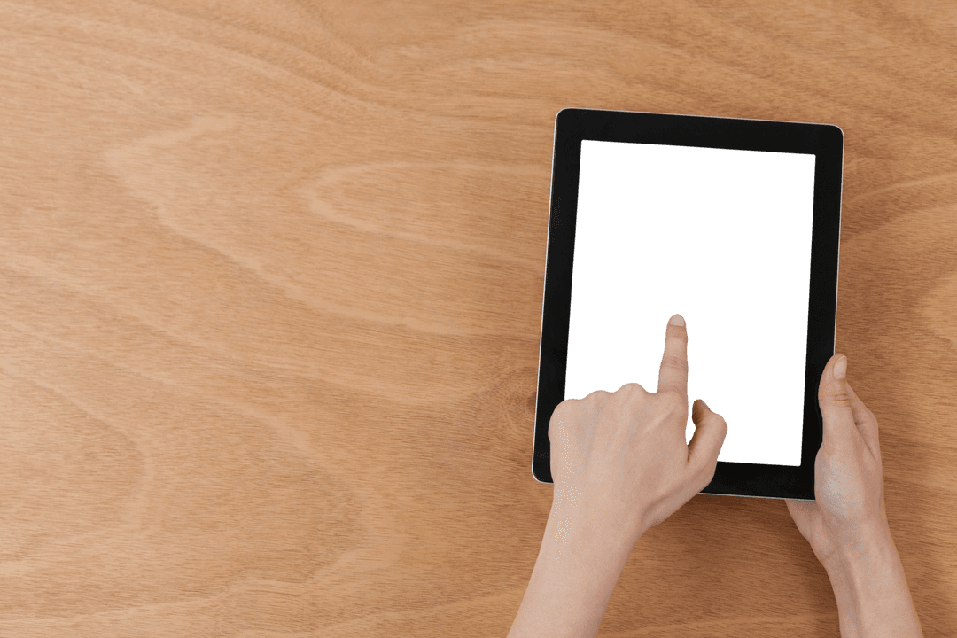 Hands Interacting with Digital Tablet on Wood Surface, Transparent Screen