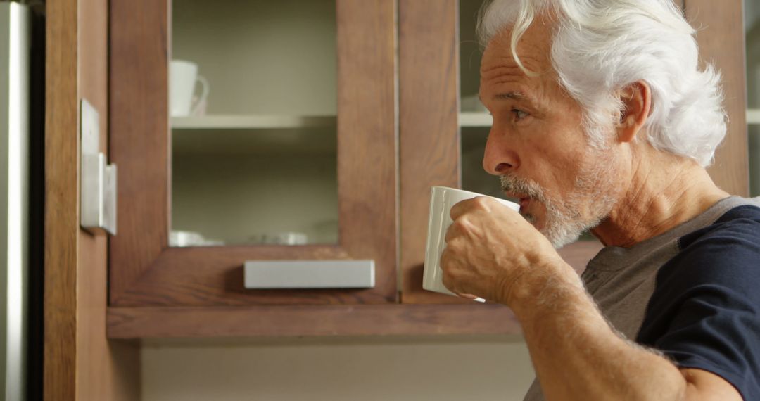 Senior Man Enjoying Coffee in Contemporary Kitchen - Free Images, Stock Photos and Pictures on Pikwizard.com