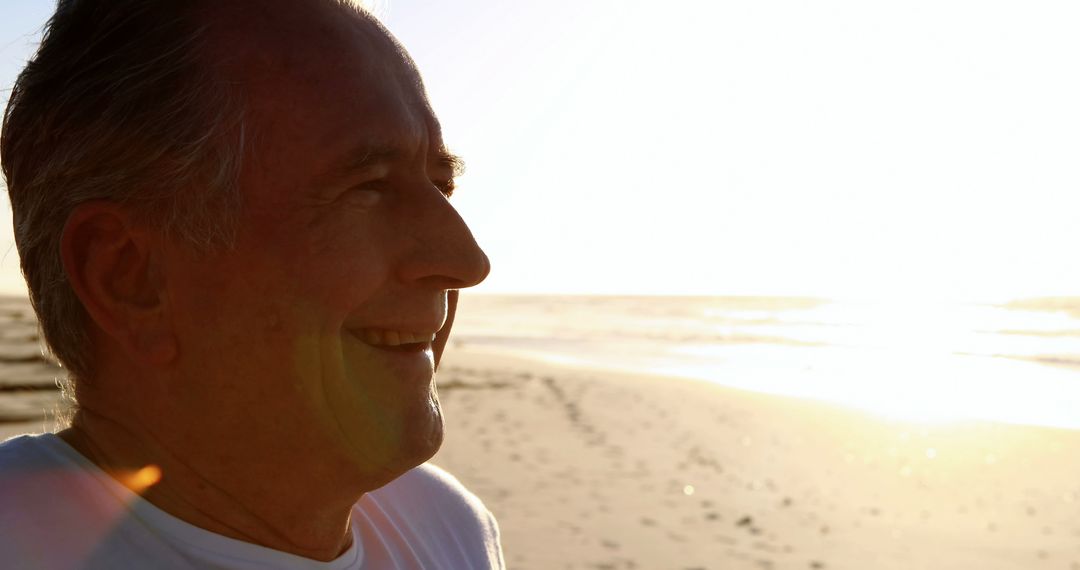 Senior Man Smiling at Sunset on Beach - Free Images, Stock Photos and Pictures on Pikwizard.com