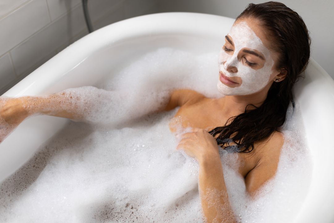 Woman Relaxing in Bathtub with Foam and Facemask - Free Images, Stock Photos and Pictures on Pikwizard.com