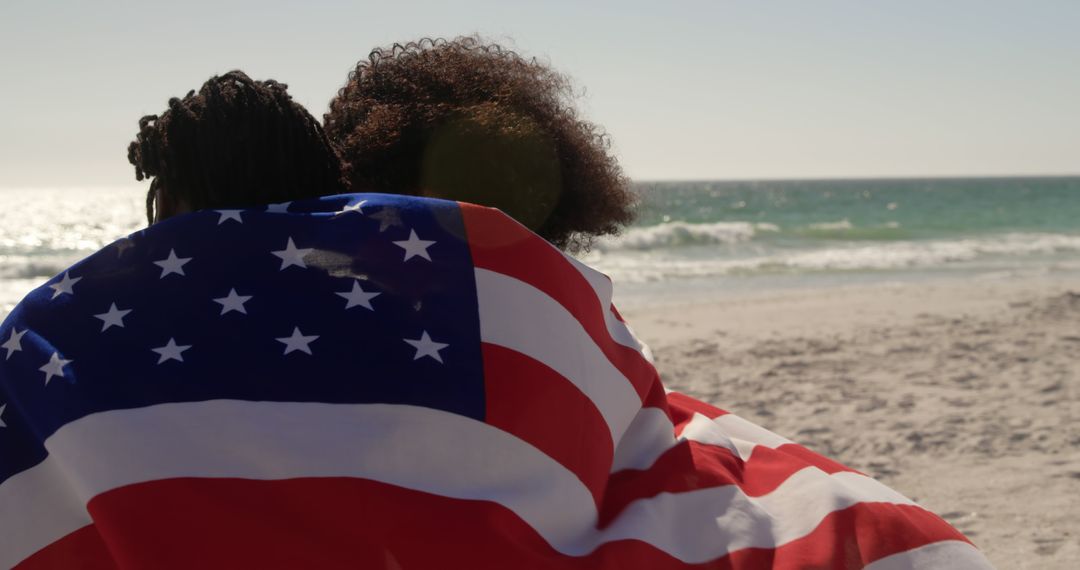 Couple Embracing Under American Flag on Beach - Free Images, Stock Photos and Pictures on Pikwizard.com