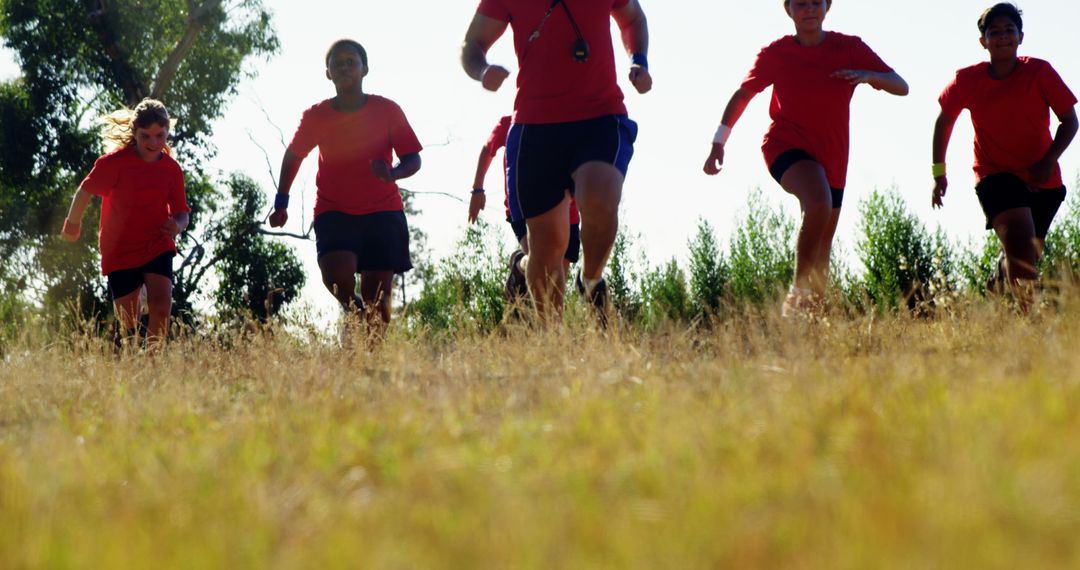 Group of Young Athletes Running Outdoors on Sunny Day - Free Images, Stock Photos and Pictures on Pikwizard.com