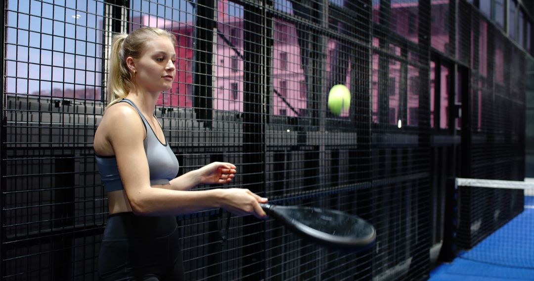 Female Athlete Practicing with Padel Racket on Court