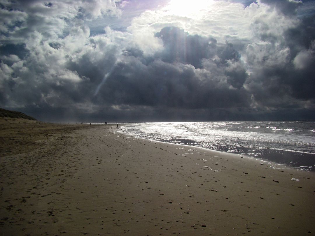 Dramatic Cloudy Sky Over an Empty Beach at Dawn - Free Images, Stock Photos and Pictures on Pikwizard.com