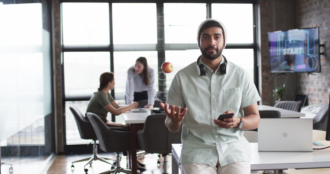Young Professional in Modern Office Environment Using Smartphone