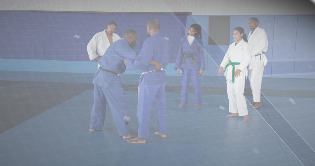 African American Men Practicing Standing Grappling Drill in Judo Class on Dojo Mats