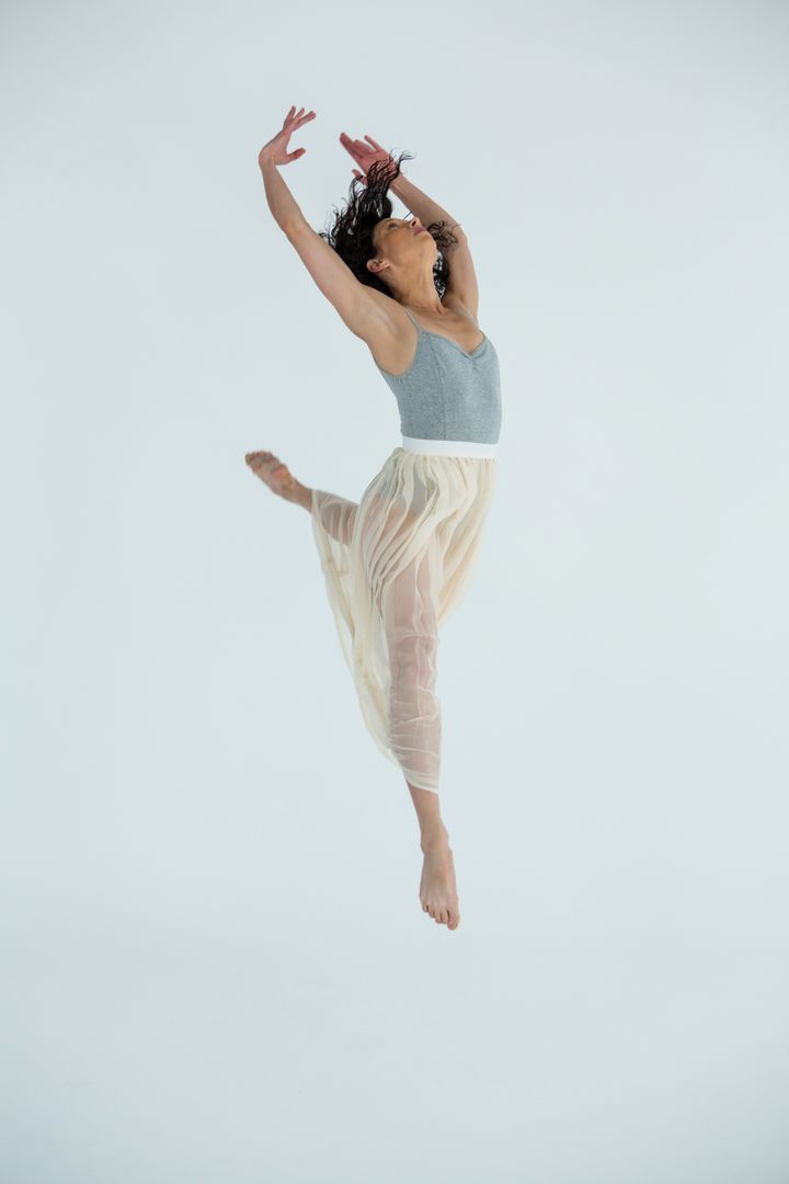 Graceful Contemporary Dancer Leaping in Studio - Free Images, Stock Photos and Pictures on Pikwizard.com