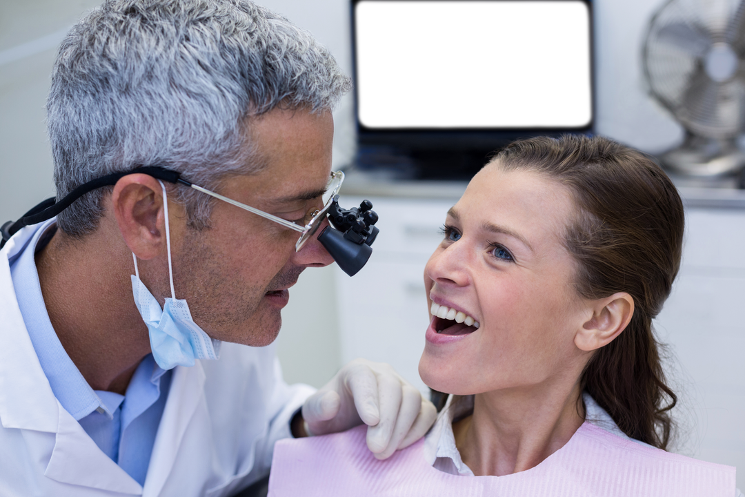 Transparent Dentist Examining Female Patient with Dental Loupes Smiling - Download Free Stock Images Pikwizard.com