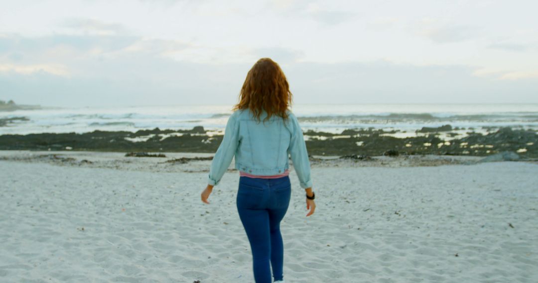 Woman Walking on a Sandy Beach at Sunset - Free Images, Stock Photos and Pictures on Pikwizard.com