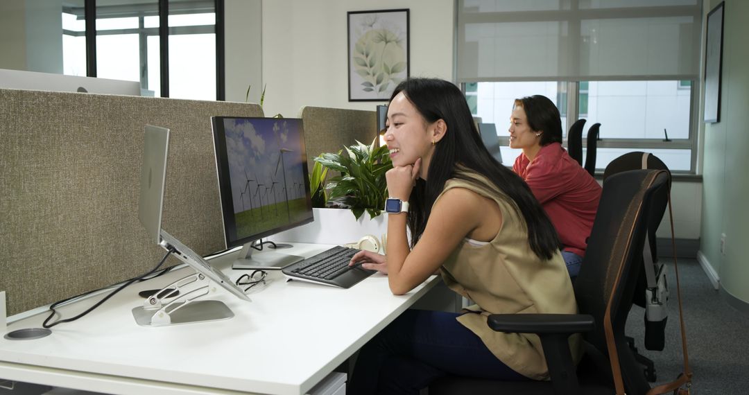 Woman Working at Office Desk Using Computer