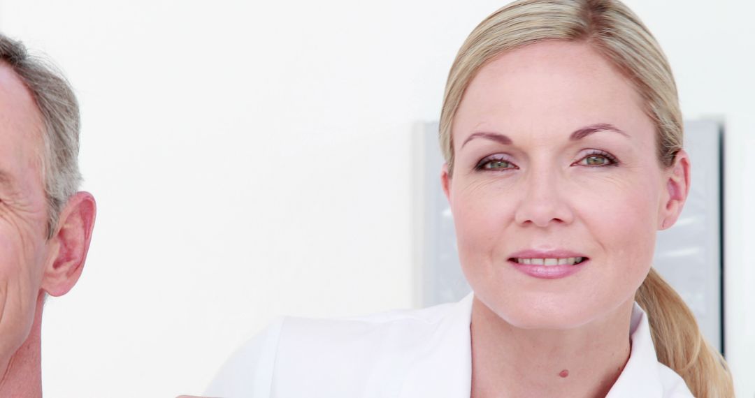 Caring Female Doctor Consulting Senior Patient with Copy Space