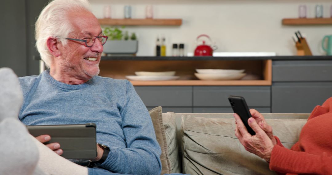 Senior Couple Enjoying Technology Together in Cozy Kitchen