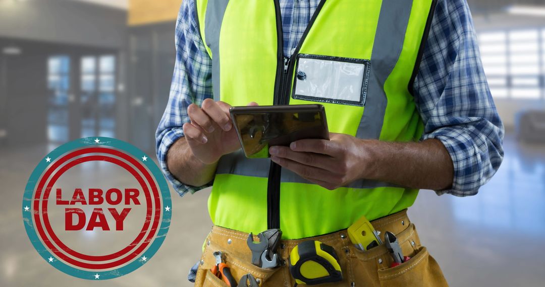Construction Worker Using Tablet With Labor Day Concept