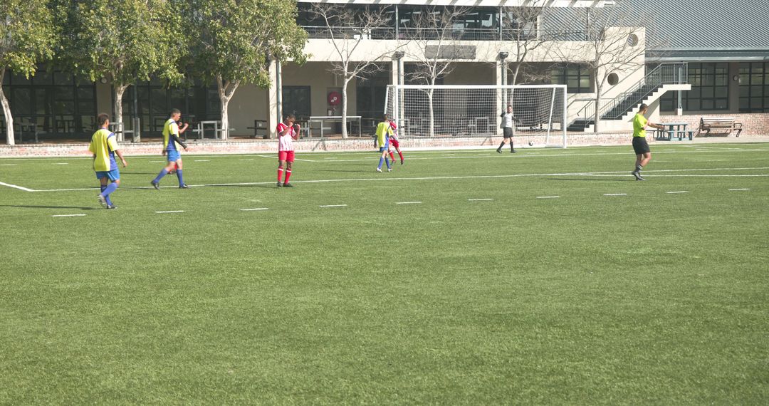Youth Soccer Team Game with Referee Interaction