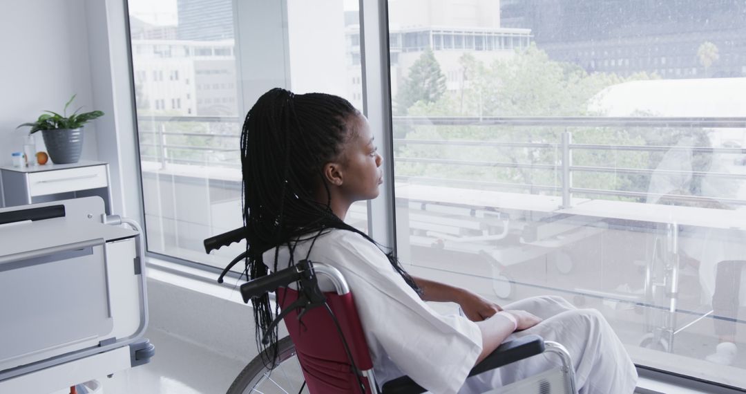 Female Patient in Wheelchair Gazing Out Hospital Window - Free Images, Stock Photos and Pictures on Pikwizard.com