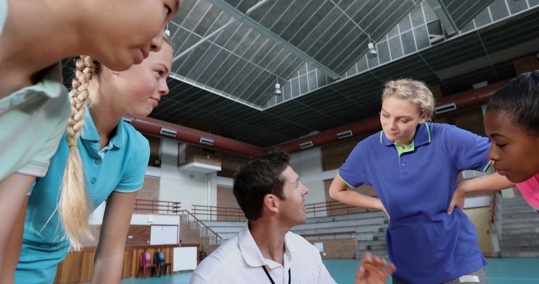 Coach Giving Strategy to Diverse Teen Athletes in Gymnasium - Free Images, Stock Photos and Pictures on Pikwizard.com