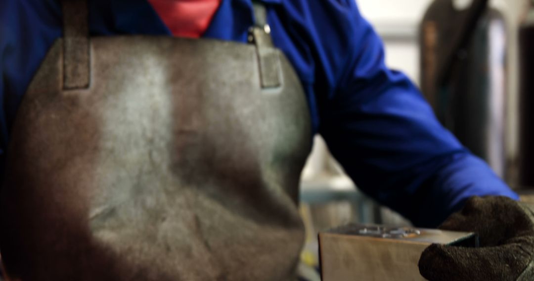 Close-up of Metalworker in Protective Apron and Gloves - Free Images, Stock Photos and Pictures on Pikwizard.com