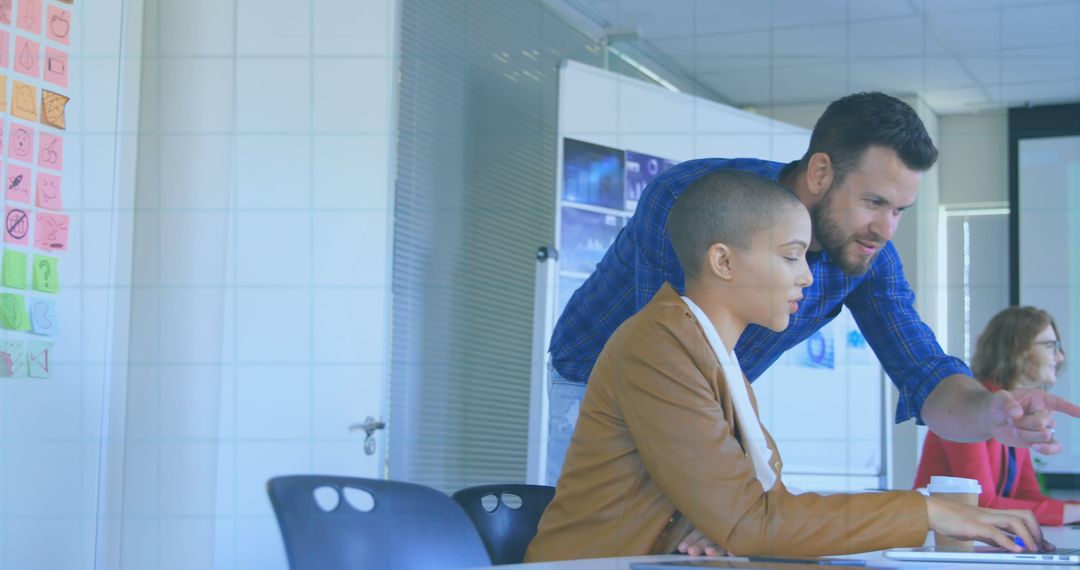 Caucasian Manager Collaborates with Biracial Colleague on Project