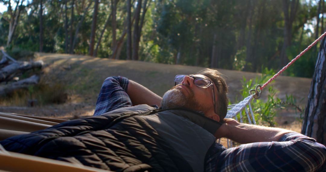 Man Relaxing in Hammock in Tranquil Forest Setting - Free Images, Stock Photos and Pictures on Pikwizard.com