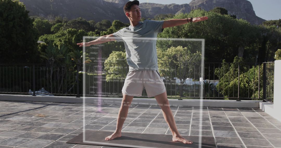 Asian man practicing yoga on terrace with code overlay blending fitness and technology