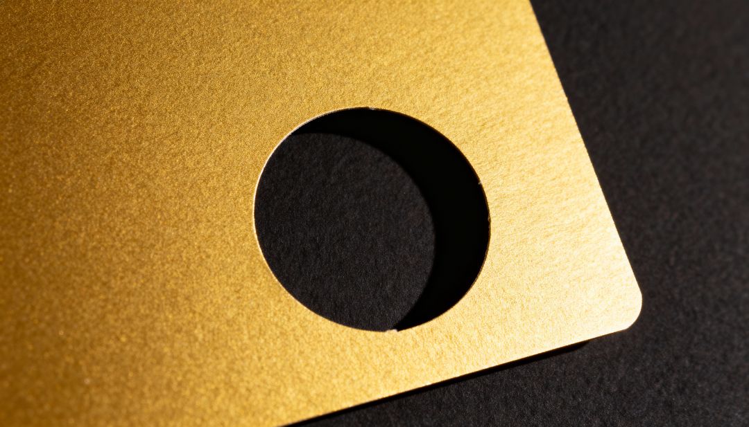 Textured Gold Die-Cut Card with Circular Hole Casting Dramatic Shadow