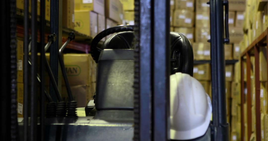 Empty Forklift in Large Warehouse With Stacks of Boxes