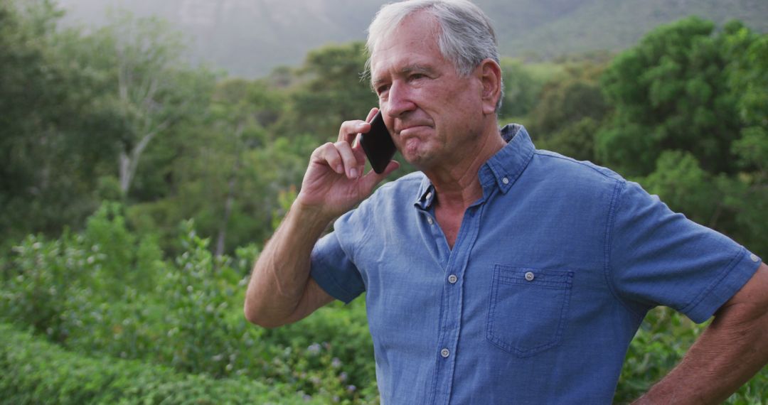 Senior Man Enjoying Phone Call in Lush Garden Environment - Free Images, Stock Photos and Pictures on Pikwizard.com