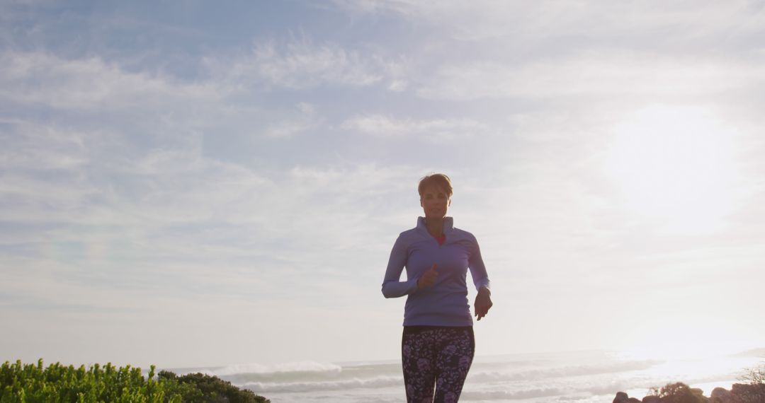 Woman Jogging Along Seaside Path at Sunrise - Free Images, Stock Photos and Pictures on Pikwizard.com