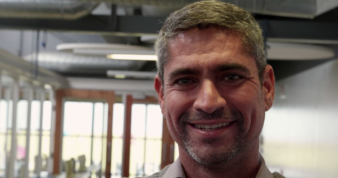 Smiling Mature Businessman in Modern Office Environment