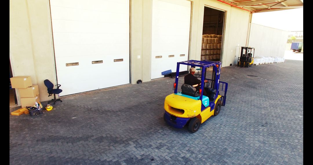 Warehouse Worker Operating Forklift in Industrial Facility - Free Images, Stock Photos and Pictures on Pikwizard.com