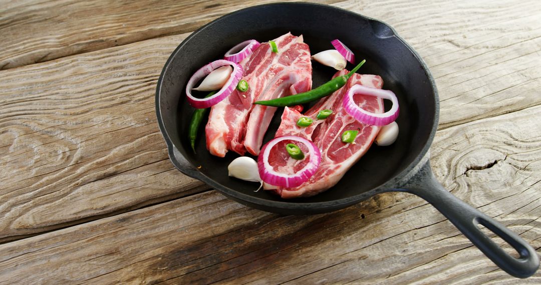 Raw Lamb Chops with Onions and Garlic in Cast Iron Pan - Free Images, Stock Photos and Pictures on Pikwizard.com