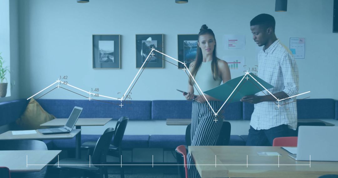 Coworkers Analyzing Graphs in Modern Office Lounge Area